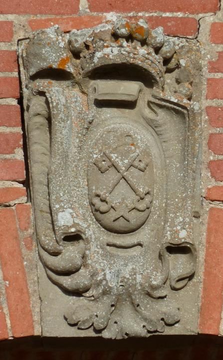 The carved arms of the abbey: a crowned cartouche, two keys in saltire
